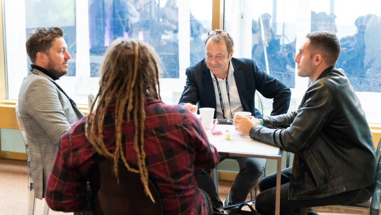 Group of people chatting around a table