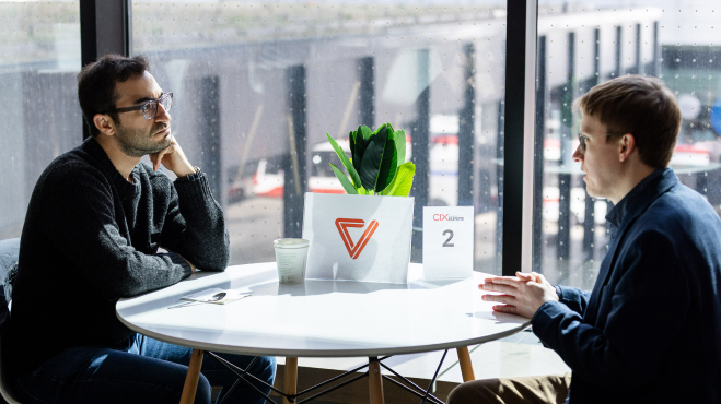 Two people sitting at a table for a meeting